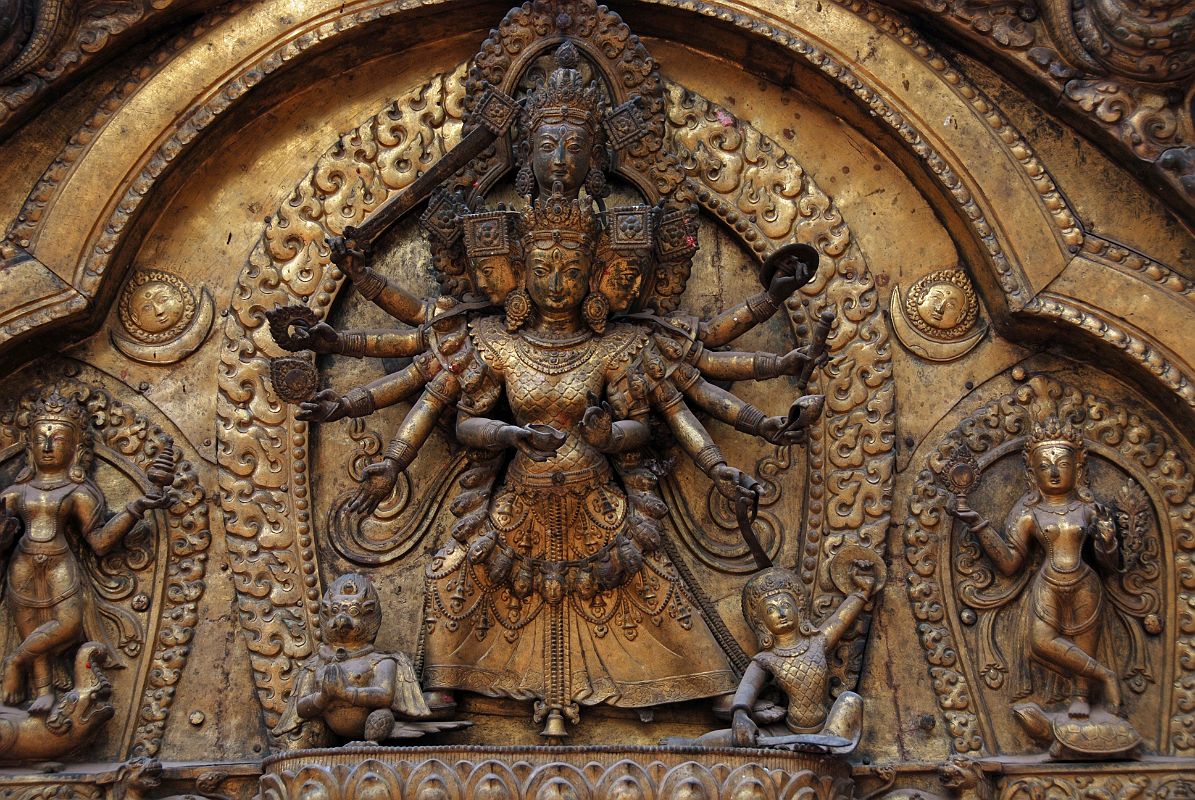 Kathmandu Bhaktapur 04-3 Bhaktapur Durbar Square Golden Gate Torana Taleju Bhawani Close Up Here is a close up of the four-headed and 10-armed figure of the goddess Taleju Bhawani directly above the door of the Golden Gate in Bhaktapurs Durbar Square. On the left Shri stand on a crocodile; on the right Lakshmi stands on a tortoise.